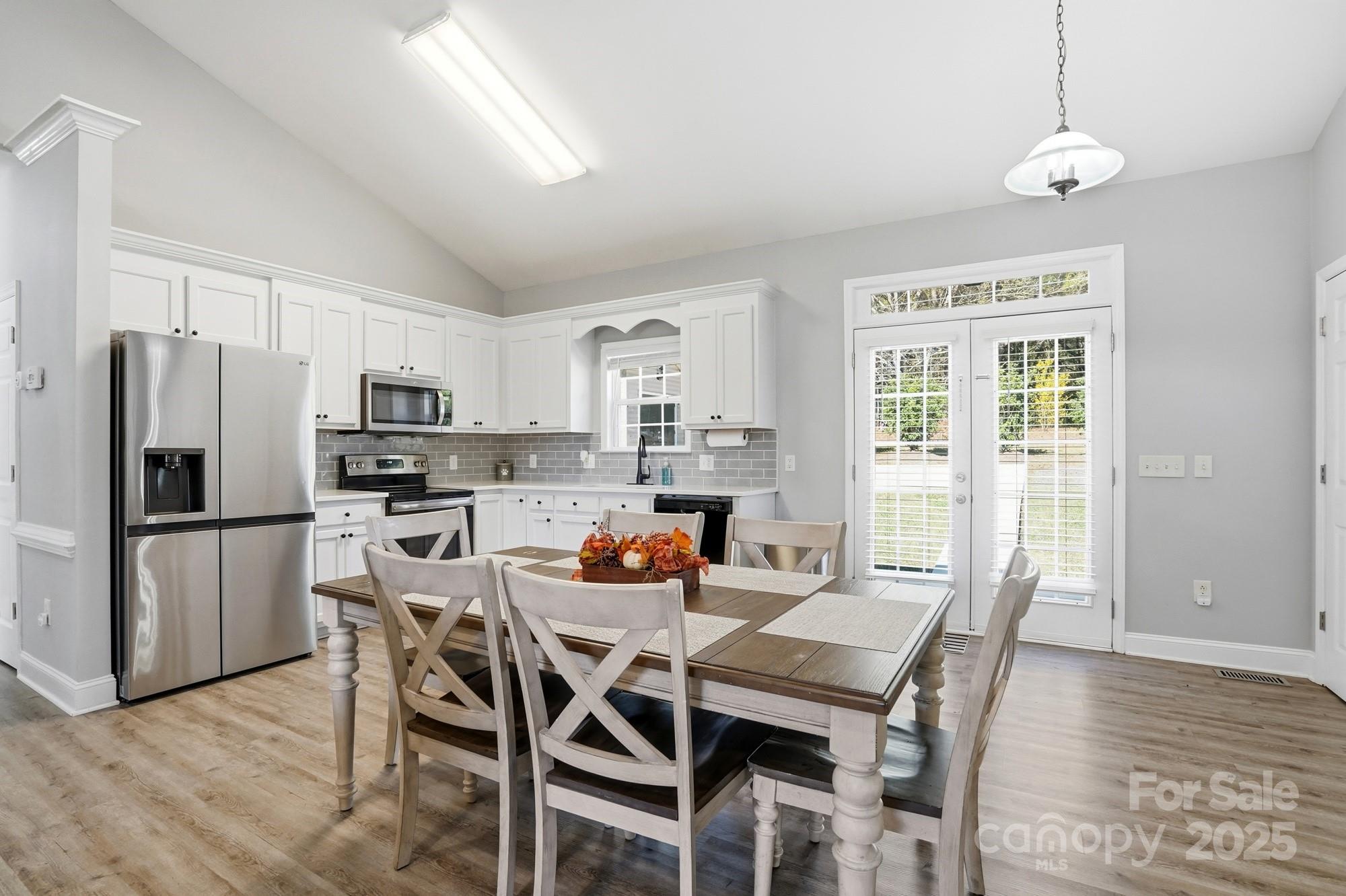 213 Carrie Road Oakboro, NC 28129 - Photo 7 of 40 a dining room with stainless steel appliances a dining table and chairs