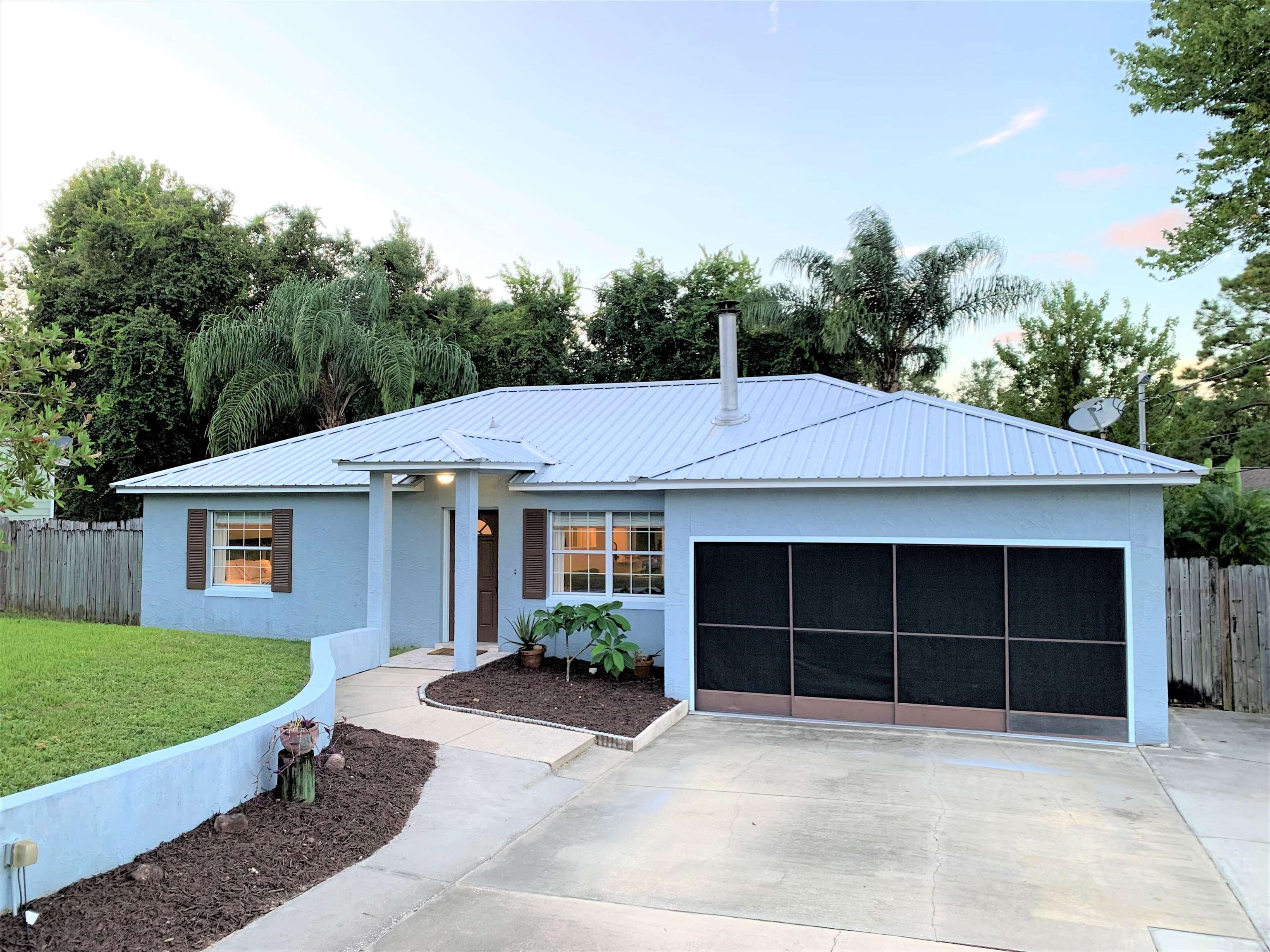 215 Yale Road St. Augustine, FL 32086 - Photo 2 of 35 a front view of a house with a yard and garage