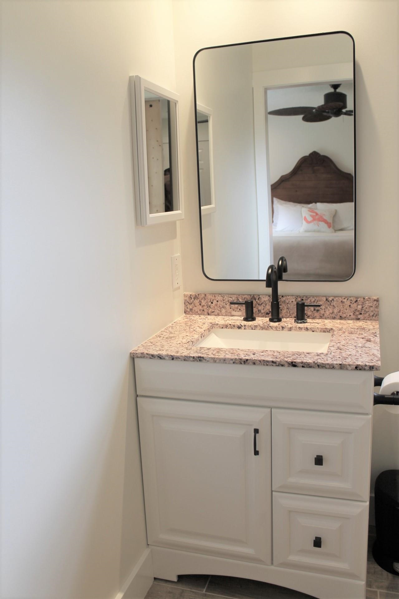 215 Yale Road St. Augustine, FL 32086 - Photo 21 of 35 a bathroom with a granite countertop sink and a mirror