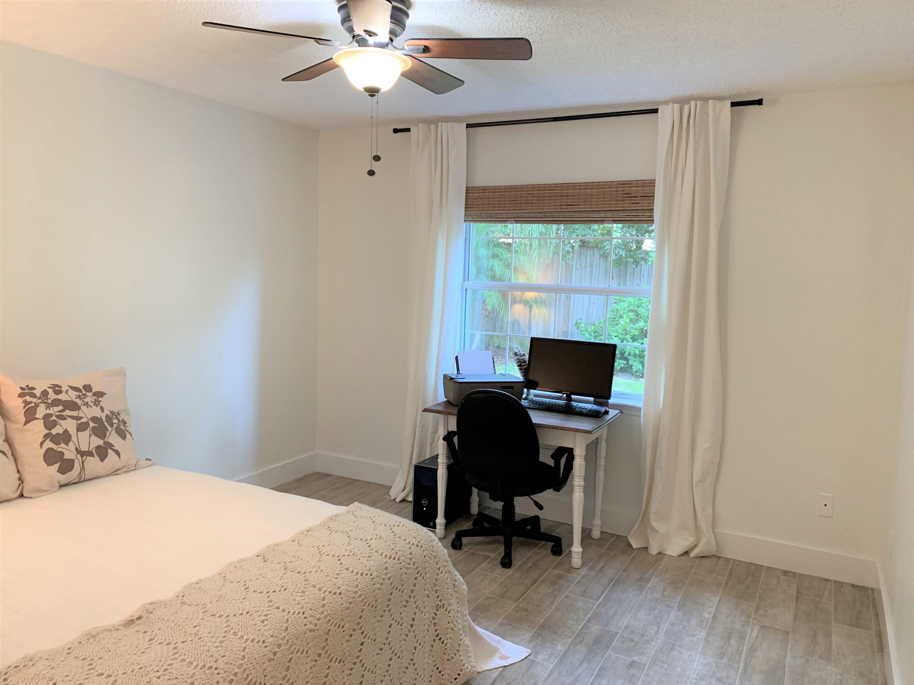 215 Yale Road St. Augustine, FL 32086 - Photo 28 of 35 a bedroom with a bed and a desk