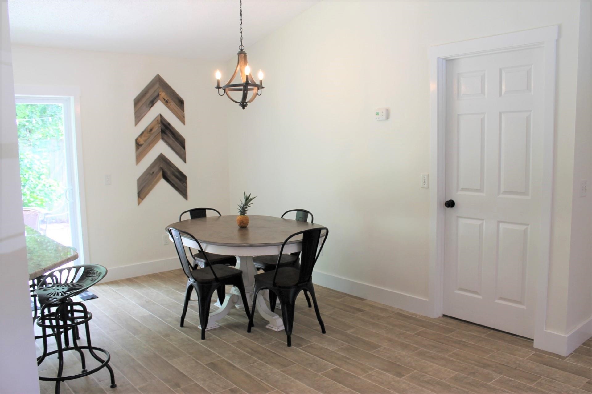 215 Yale Road St. Augustine, FL 32086 - Photo 10 of 35 a view of a dining room with furniture and wooden floor