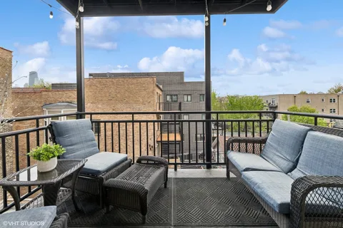 a view of a balcony with furniture