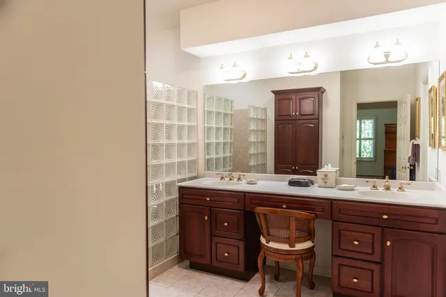 a spacious bathroom with a granite countertop sink a mirror and a