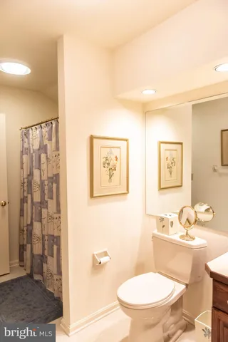 a white toilet sitting next to a bathroom sink