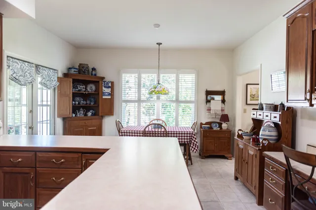 a living room with furniture a flat screen tv and large windows