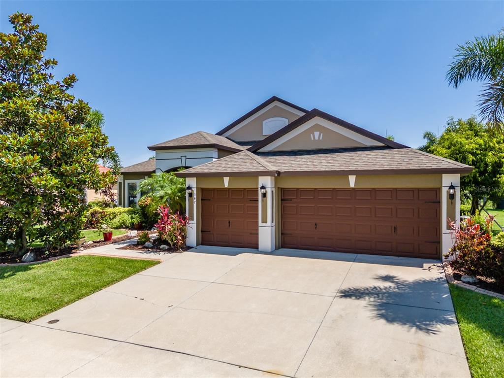347 Cockle Shell Loop Apollo Beach, FL 33572 - Photo 1 of 1 a front view of a house with a yard and garage