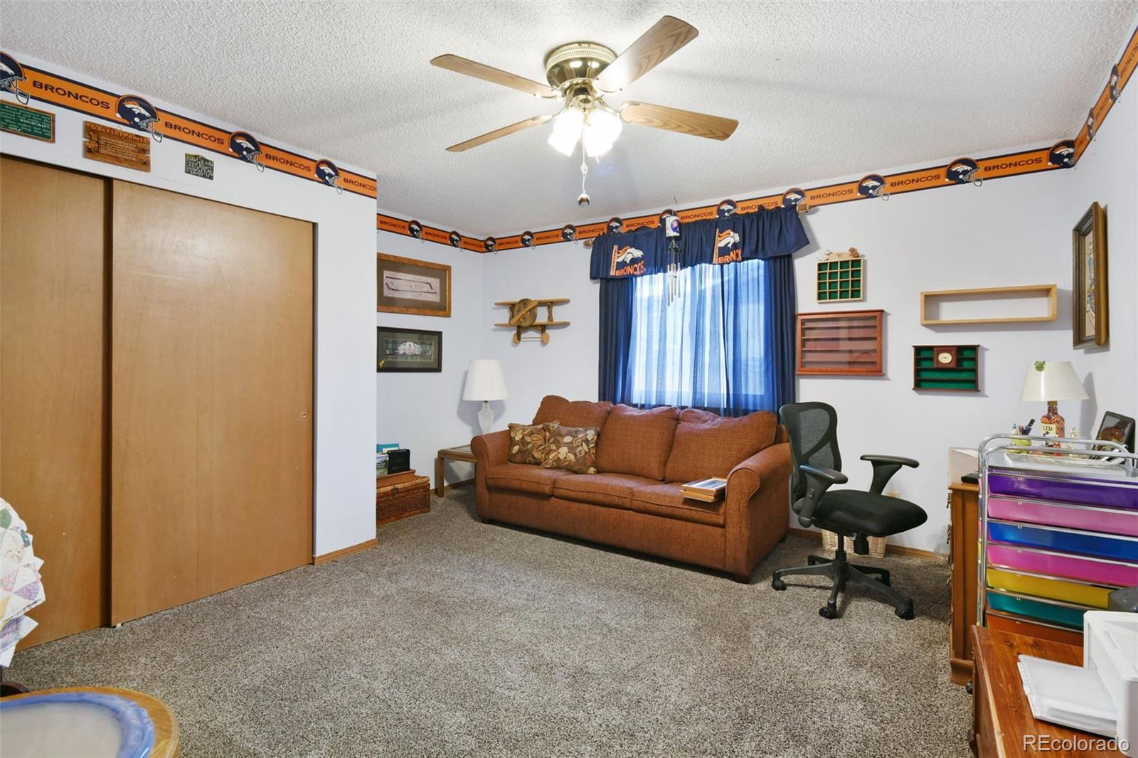 1360 Yank Street Golden, CO 80401 - Photo 11 of 26 a living room with furniture a ceiling fan and a rug