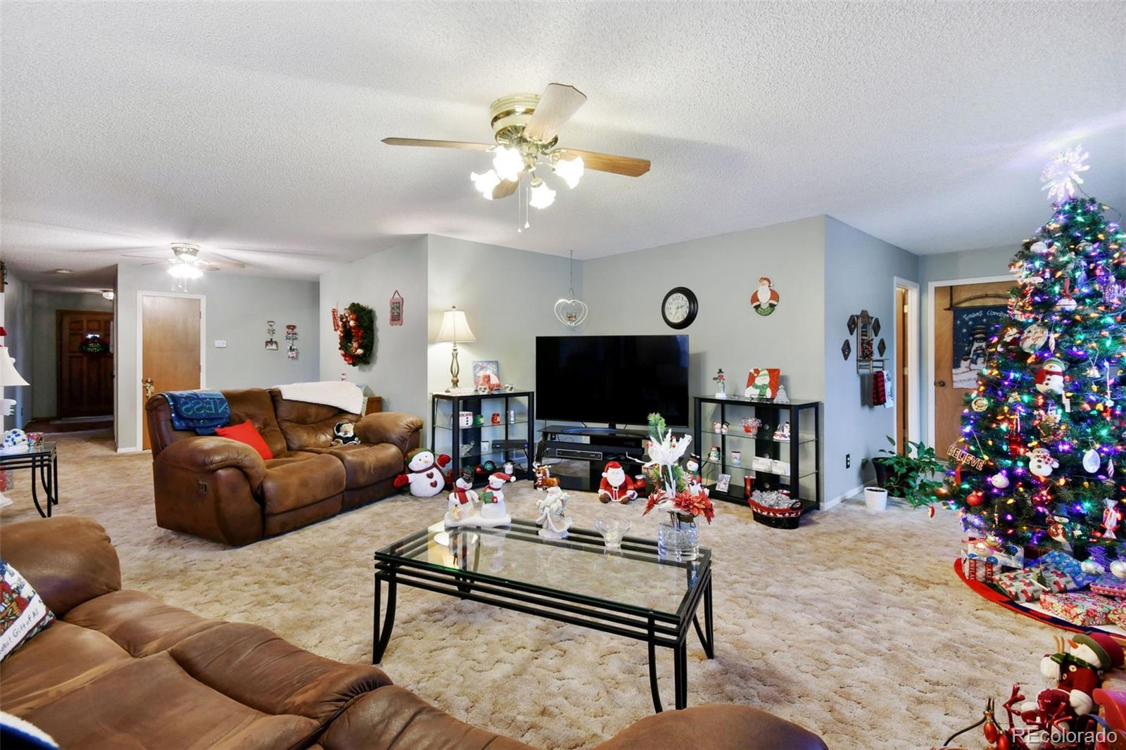 1360 Yank Street Golden, CO 80401 - Photo 17 of 26 a living room with furniture and a flat screen tv