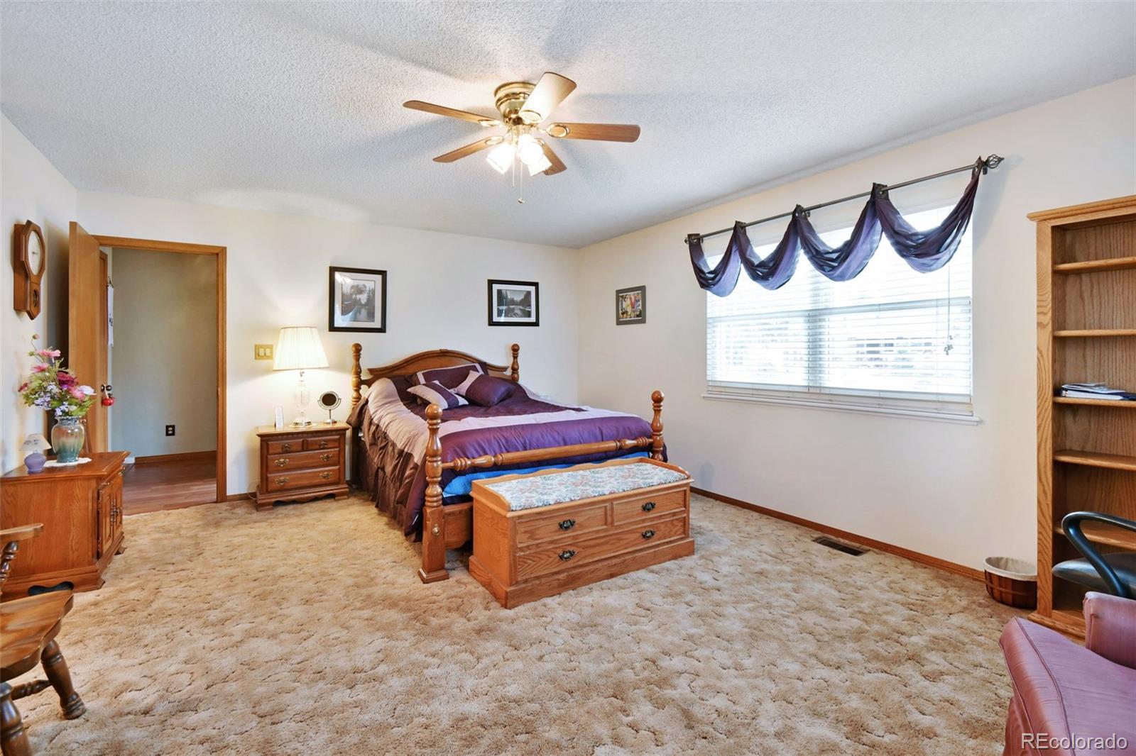 1360 Yank Street Golden, CO 80401 - Photo 18 of 26 a bedroom with furniture and a chandelier