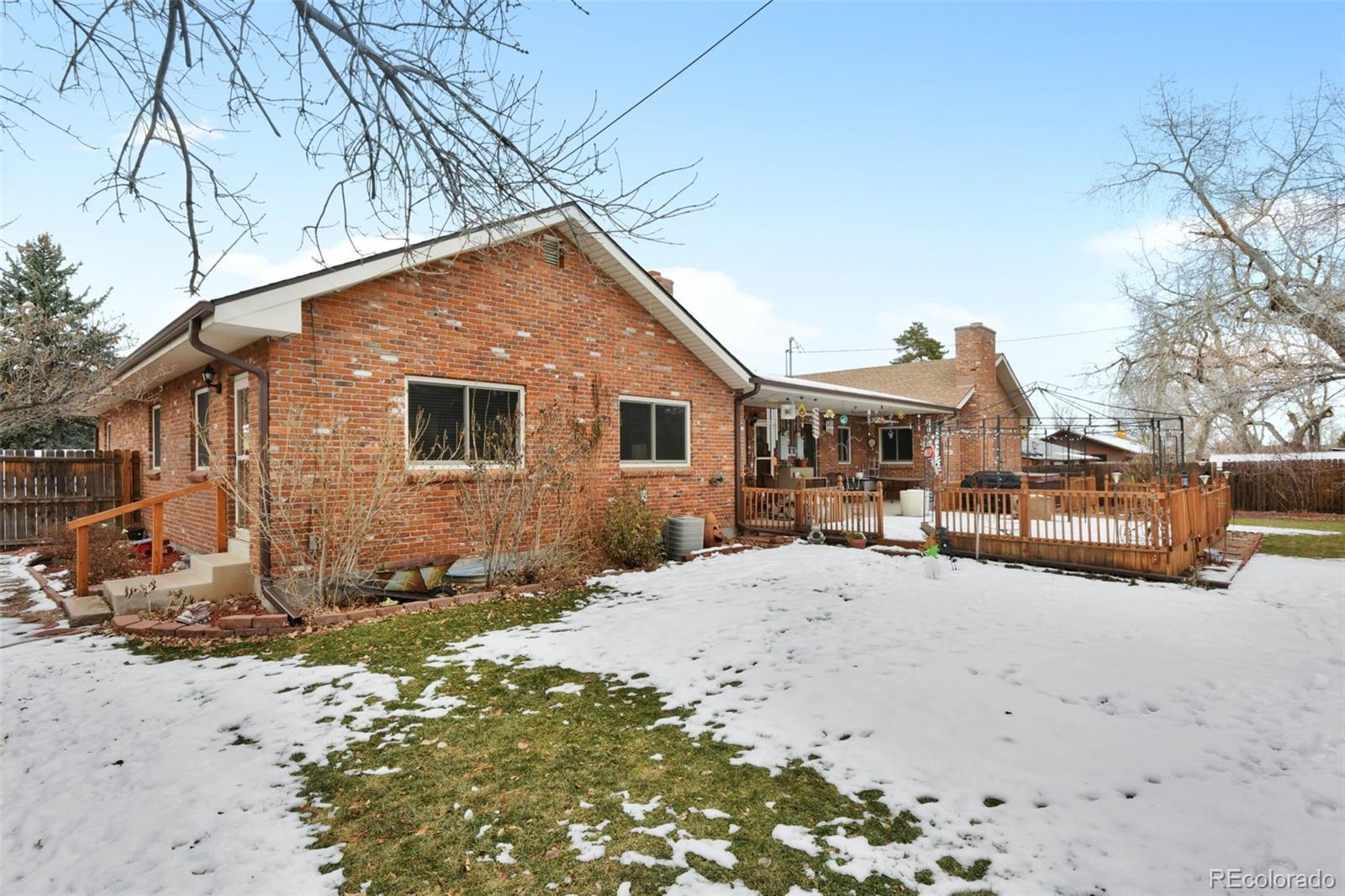 1360 Yank Street Golden, CO 80401 - Photo 23 of 26 a front view of a house with a yard covered in snow