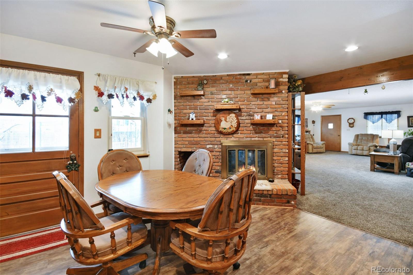 1360 Yank Street Golden, CO 80401 - Photo 6 of 26 a living room with furniture a chandelier and a dining table