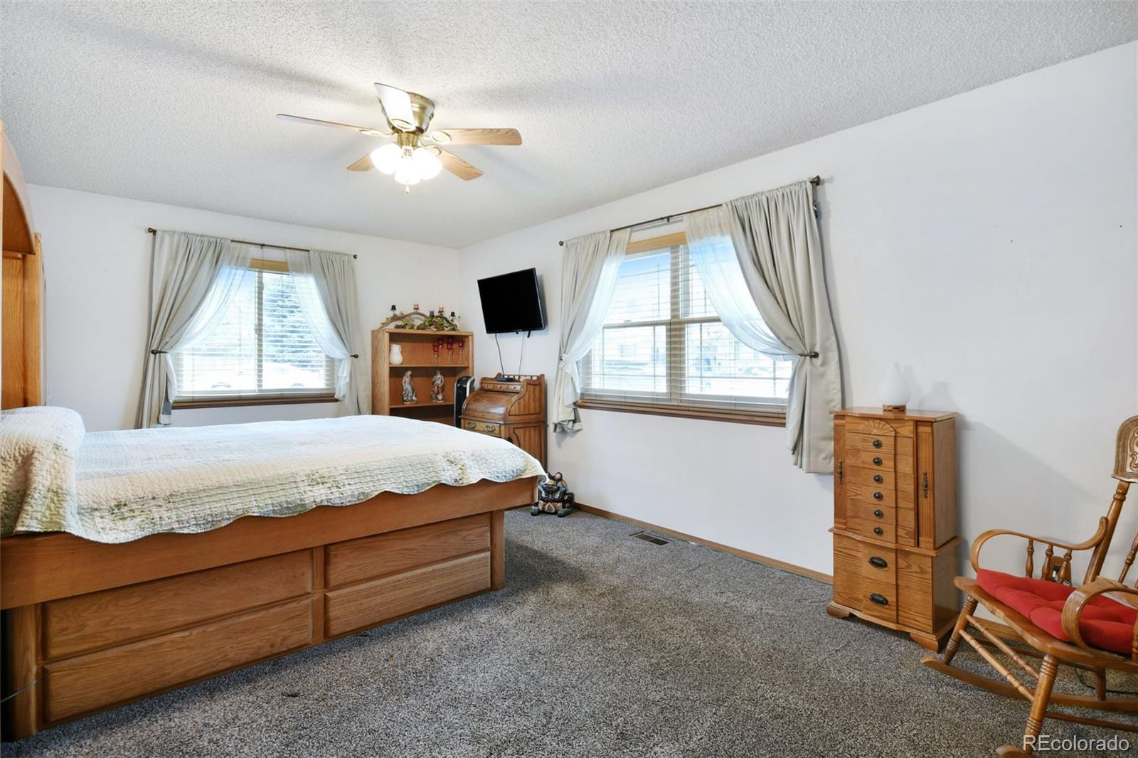 1360 Yank Street Golden, CO 80401 - Photo 8 of 26 a spacious bedroom with a bed and a window
