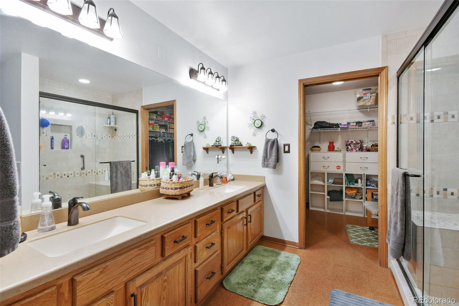 1360 Yank Street Golden, CO 80401 - Photo 9 of 26 a spacious bathroom with double vanity and a shower