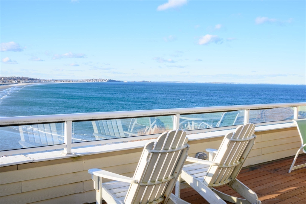 a view of a balcony with chair and wooden floor