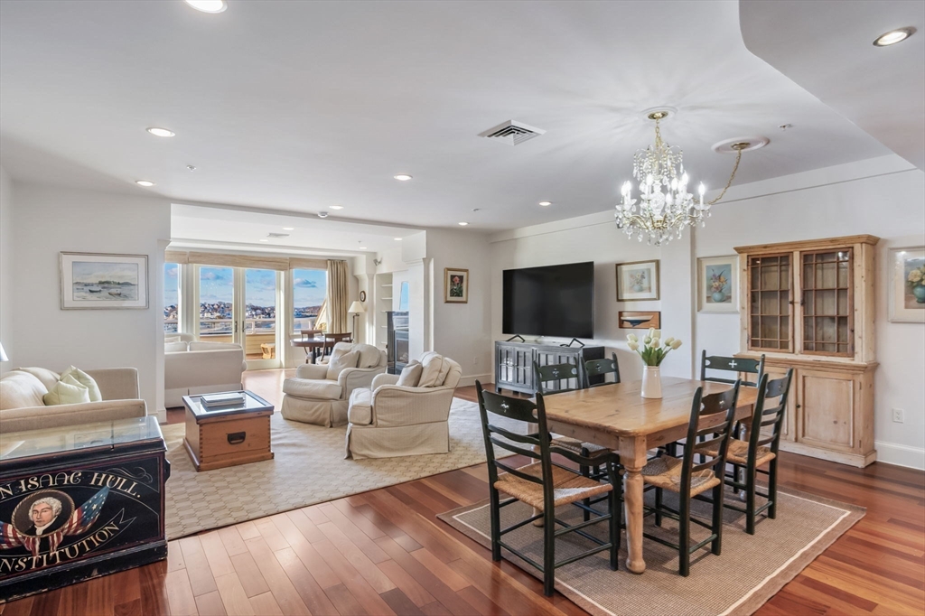 1 Longbeach Avenue, Unit 202 Hull, MA 02045 - Photo 11 of 40 a view of a dining room with furniture a chandelier and wooden floor