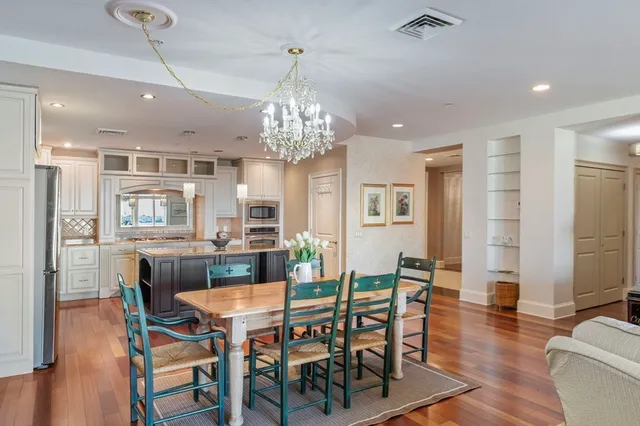 a view of a dining room with furniture wooden floor and chandelier