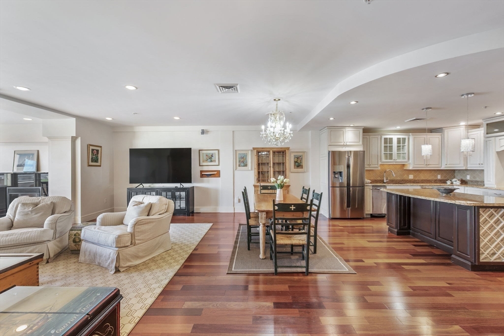 1 Longbeach Avenue, Unit 202 Hull, MA 02045 - Photo 13 of 40 a living room with furniture wooden floor and a kitchen