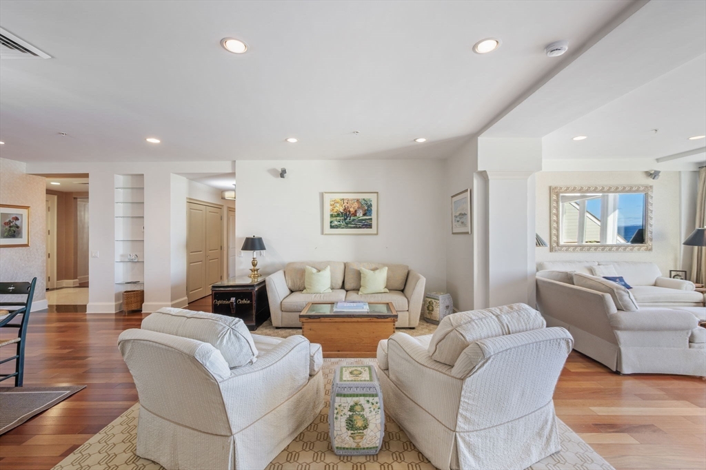 1 Longbeach Avenue, Unit 202 Hull, MA 02045 - Photo 14 of 40 a living room with furniture and a wooden floor