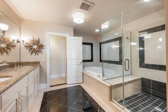 a bathroom with a tub sink and mirror