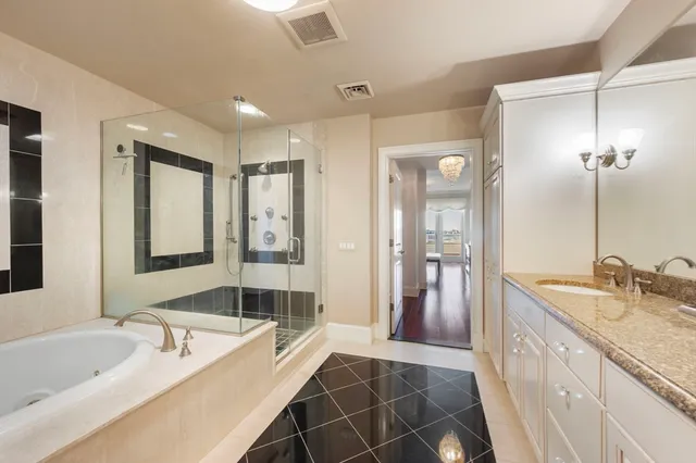 a spacious bathroom with a double vanity sink shower and a mirror