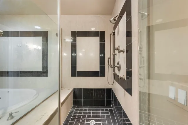 a bathroom with a bathtub and a shower