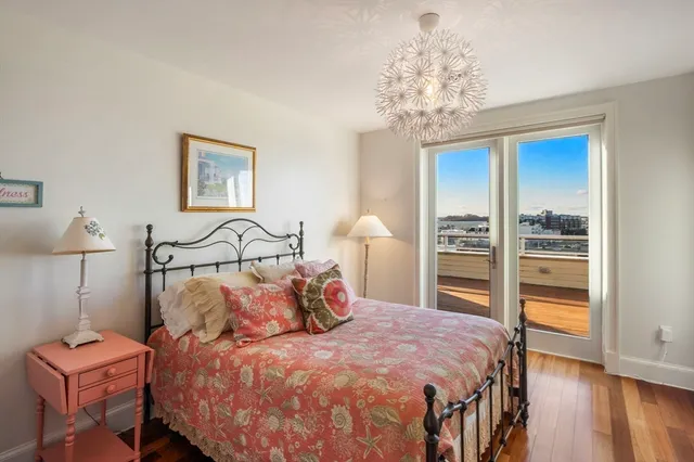 a bedroom with a bed and a chandelier