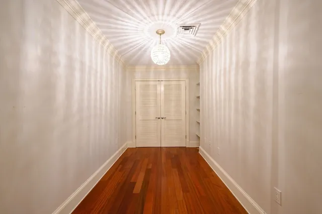 a view of a room with wooden floor fan and a window