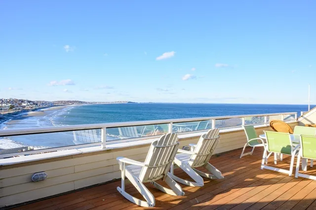 a view of a patio with table and chairs a barbeque with wooden floor and fence