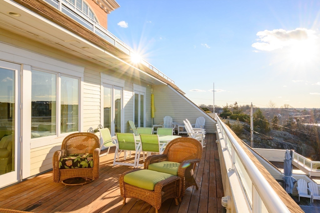 1 Longbeach Avenue, Unit 202 Hull, MA 02045 - Photo 35 of 40 a balcony with chairs and with potted plants