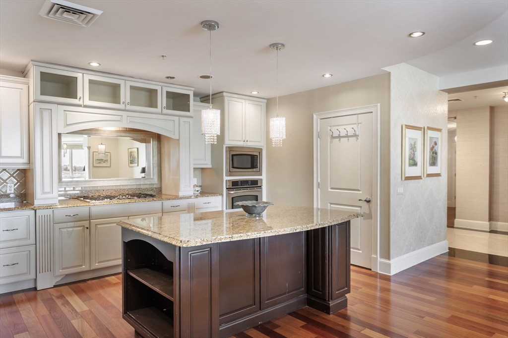 1 Longbeach Avenue, Unit 202 Hull, MA 02045 - Photo 5 of 40 a kitchen with a sink stove and refrigerator