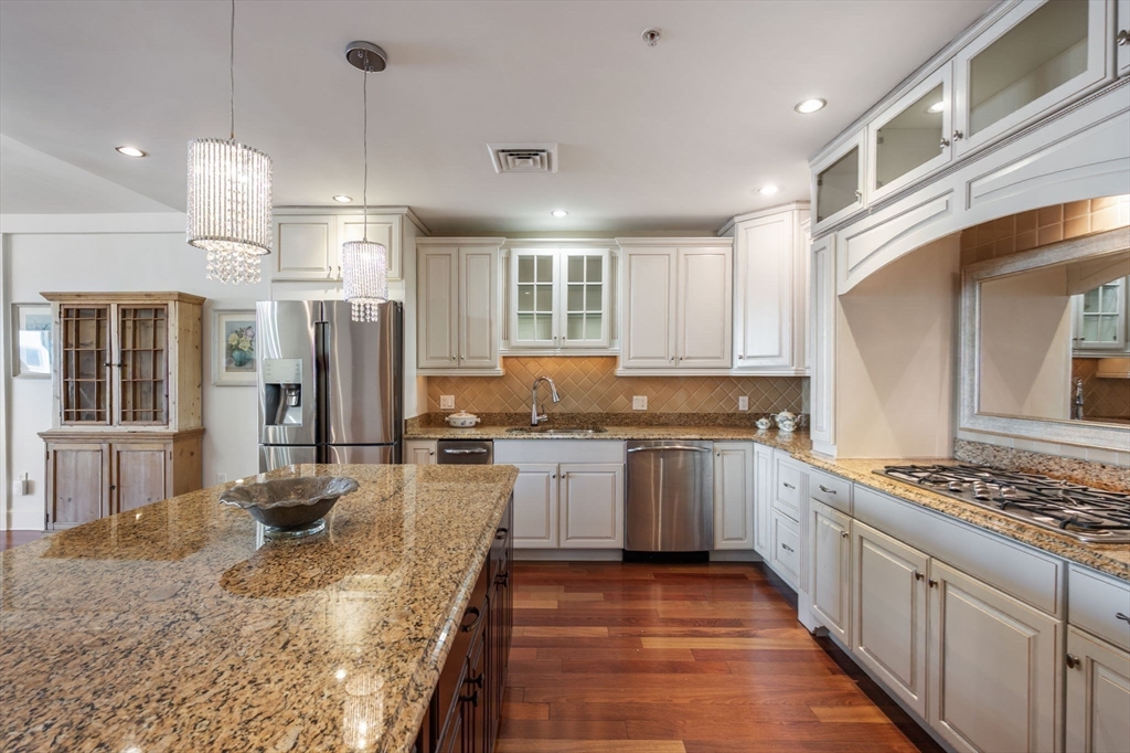 1 Longbeach Avenue, Unit 202 Hull, MA 02045 - Photo 6 of 40 a kitchen with stainless steel appliances granite countertop a sink stove and refrigerator