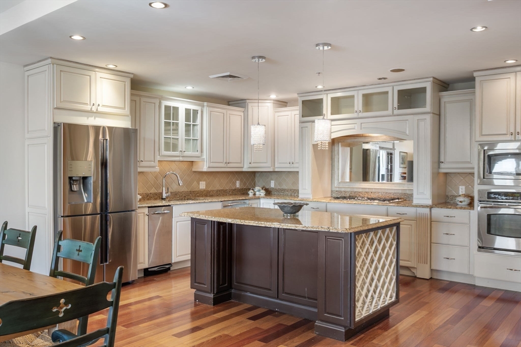 1 Longbeach Avenue, Unit 202 Hull, MA 02045 - Photo 9 of 40 a kitchen with stainless steel appliances granite countertop a refrigerator a stove and a sink