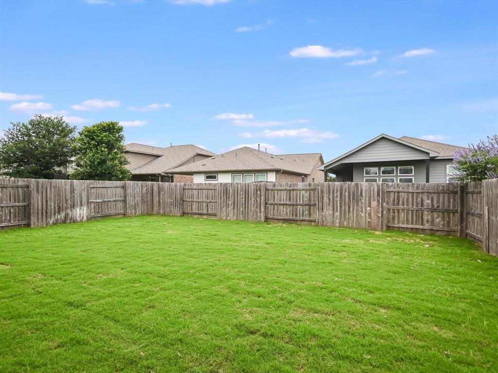 736 Bonnet Boulevard Georgetown, TX 78628 - Photo 17 of 27 a view of a backyard with a garden and deck