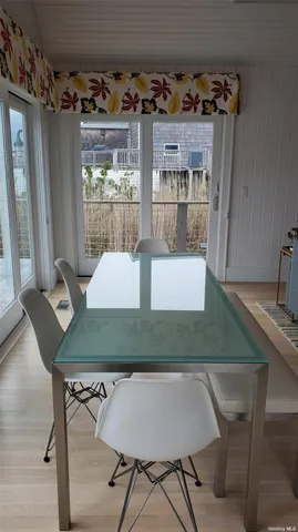 a view of a dining room with furniture and window