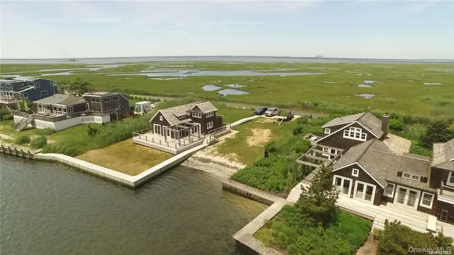 a view of a lake with a table and chairs