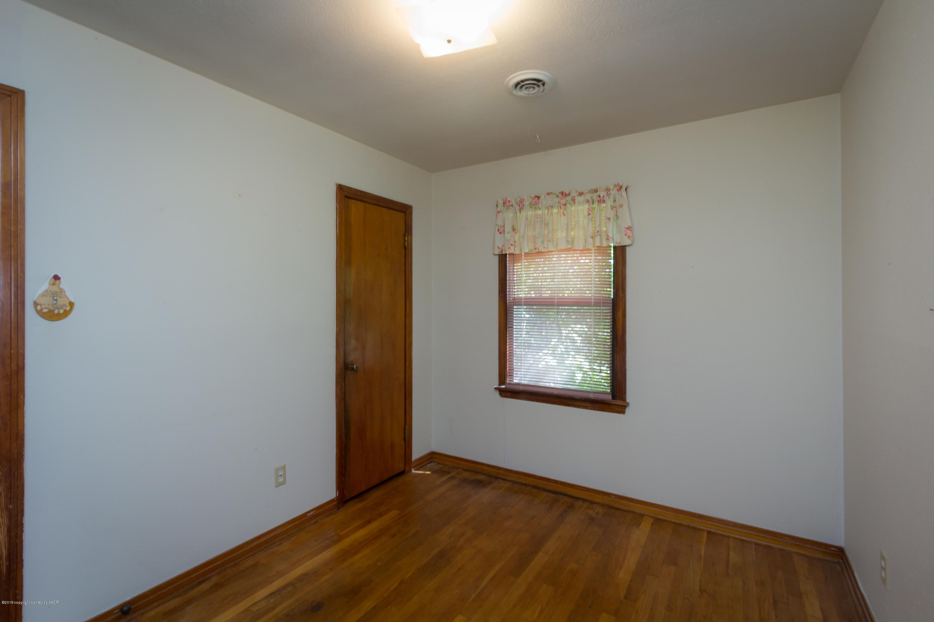 4606 Bowie Street Amarillo, TX 79110 - Photo 11 of 42 a view of an empty room with window and closet area