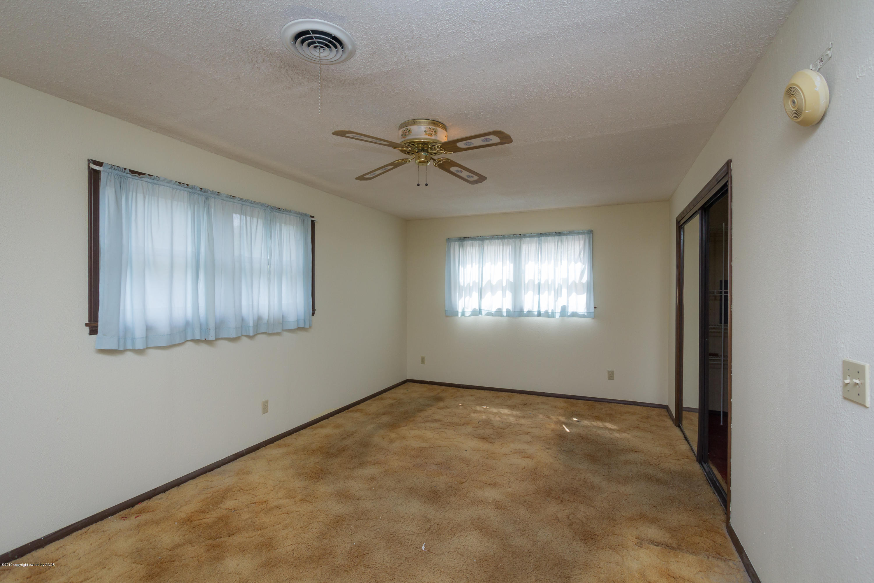 4606 Bowie Street Amarillo, TX 79110 - Photo 12 of 42 a view of an empty room with a window