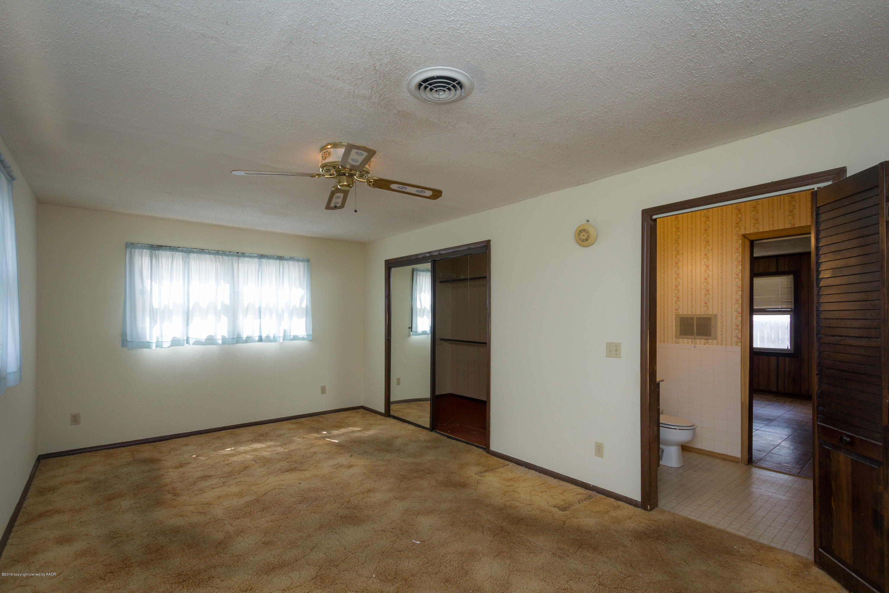 4606 Bowie Street Amarillo, TX 79110 - Photo 13 of 42 a view of an empty room with a window