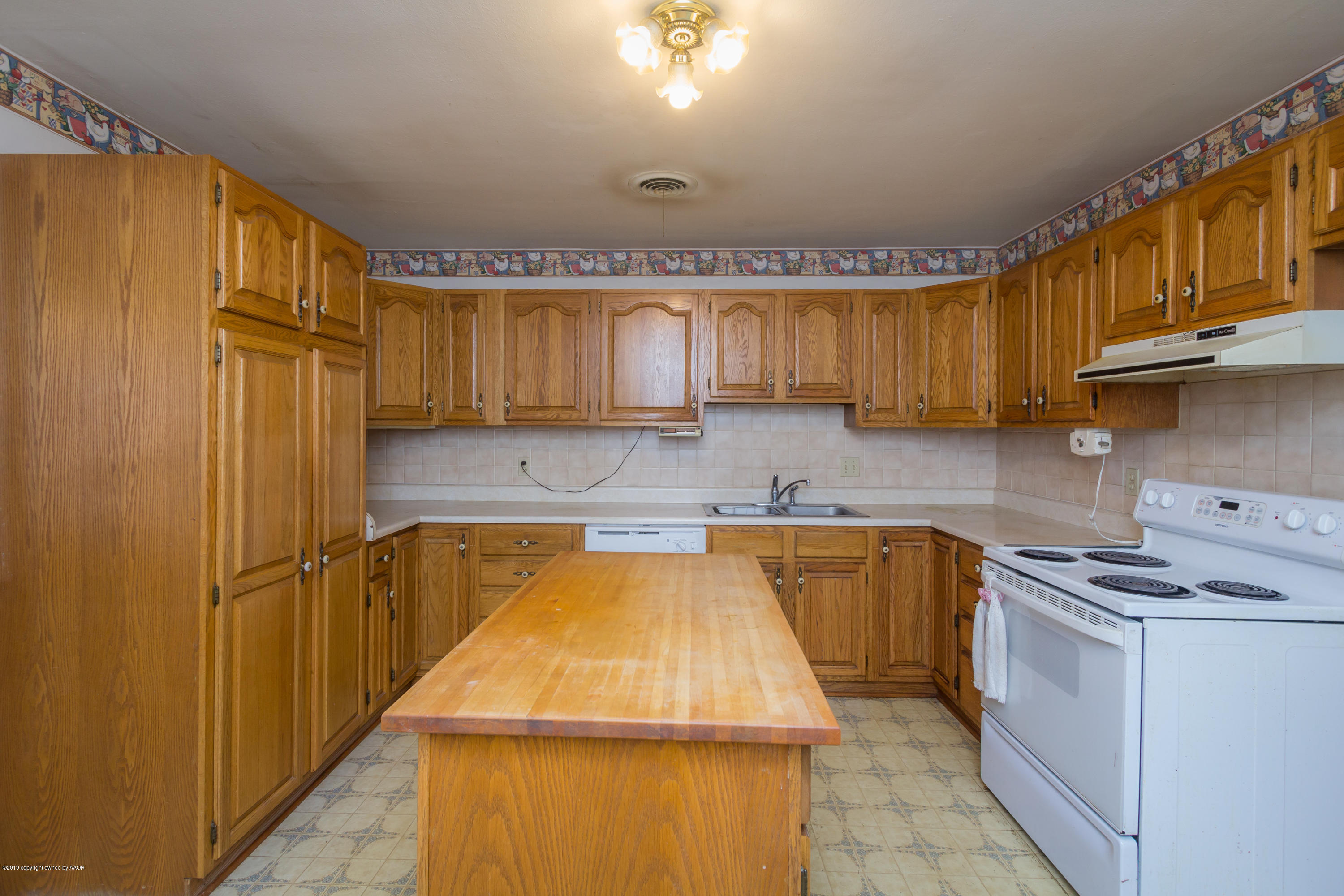 4606 Bowie Street Amarillo, TX 79110 - Photo 23 of 42 a kitchen with cabinets a sink and a stove top oven