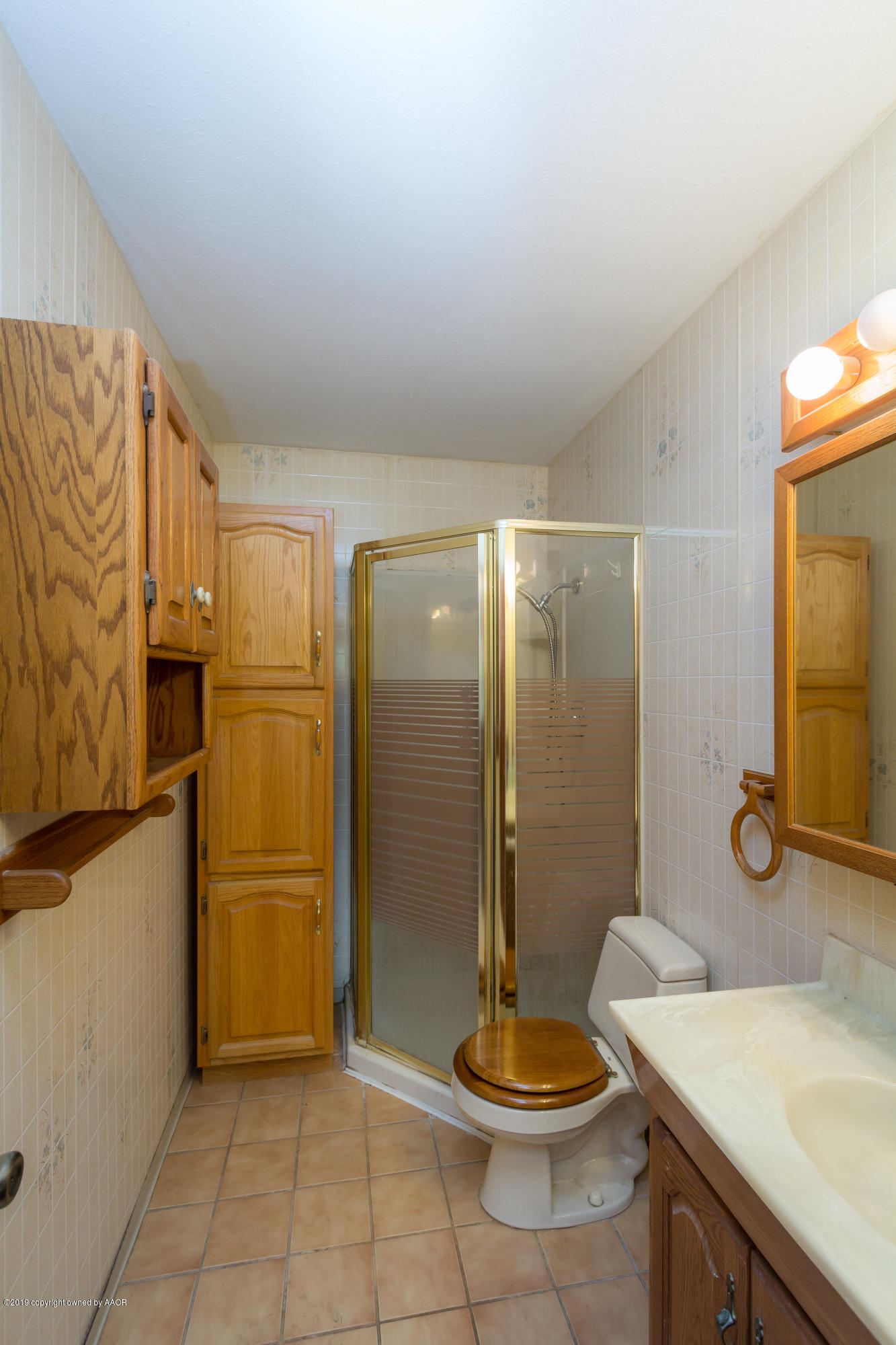 4606 Bowie Street Amarillo, TX 79110 - Photo 33 of 42 a bathroom with a sink a toilet and shower
