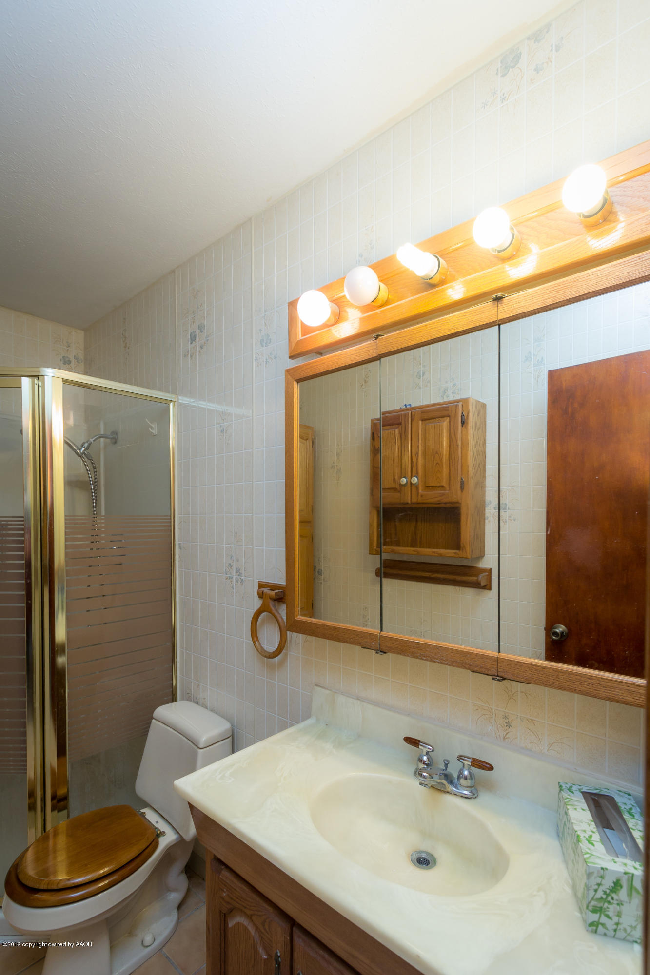 4606 Bowie Street Amarillo, TX 79110 - Photo 34 of 42 a bathroom with a sink and a mirror
