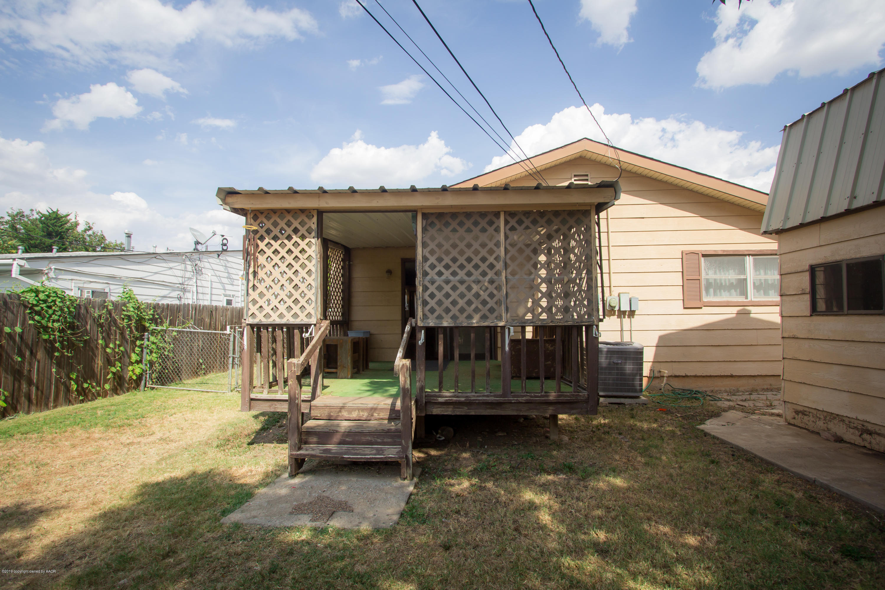 4606 Bowie Street Amarillo, TX 79110 - Photo 42 of 42 a small house with a table and chairs under an umbrella