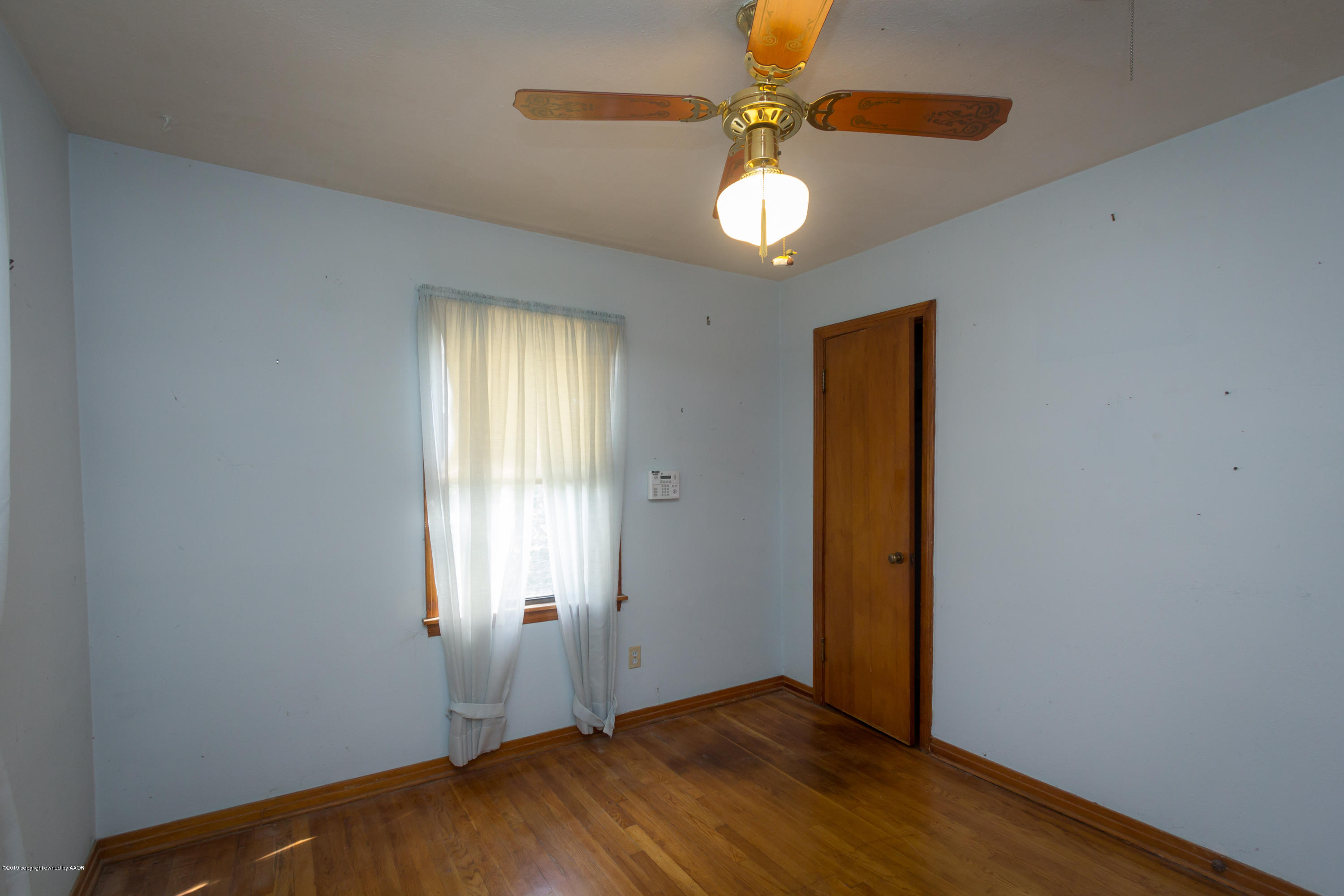 4606 Bowie Street Amarillo, TX 79110 - Photo 6 of 42 an empty room with windows and fan