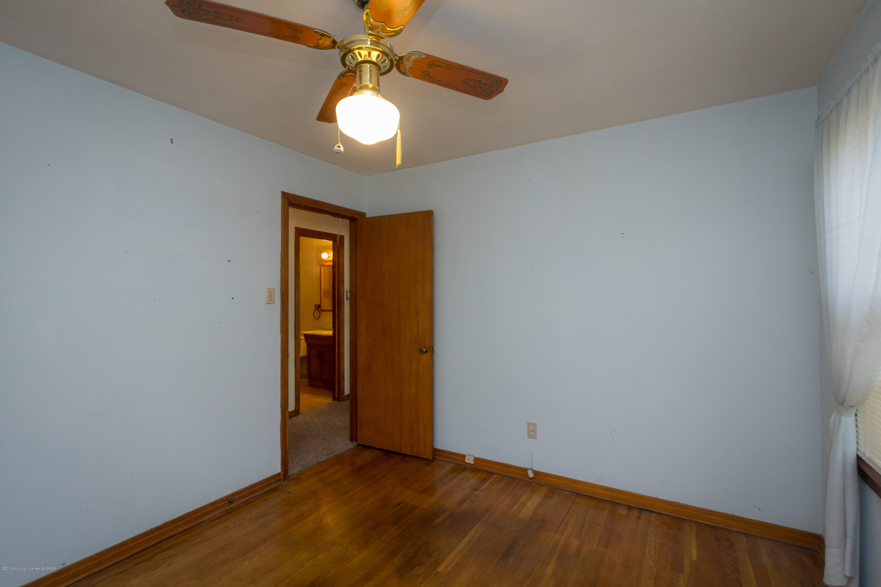 4606 Bowie Street Amarillo, TX 79110 - Photo 7 of 42 wooden floor in an empty room