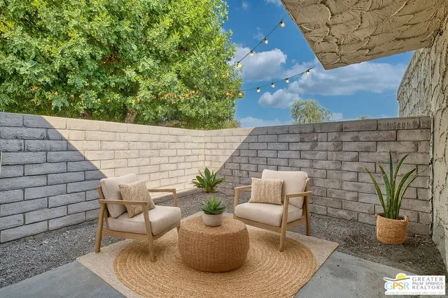 a view of a patio with couches and potted plants