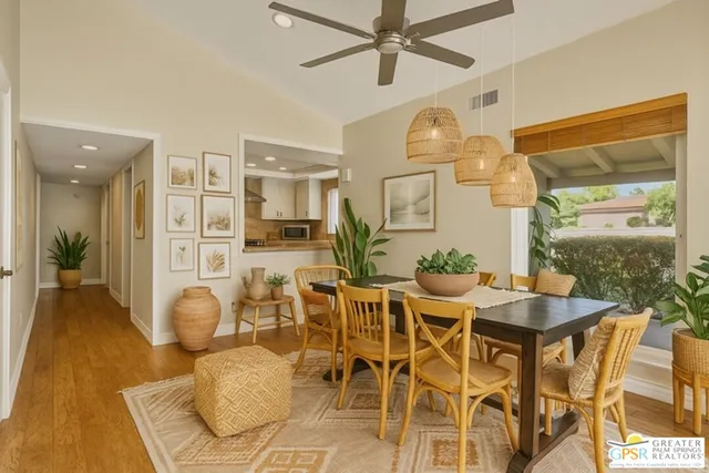 a view of a dining room with furniture and a chandelier