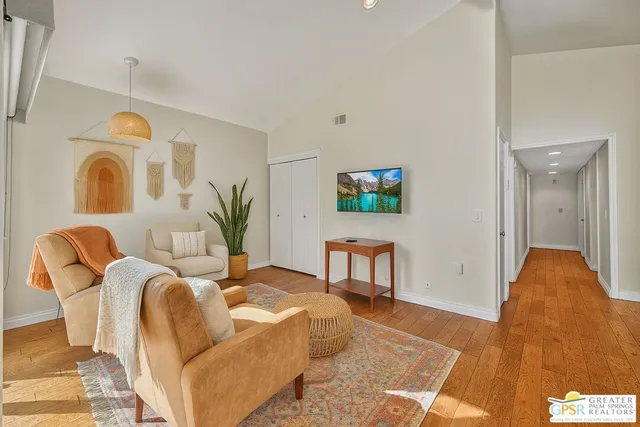 a living room with furniture a couch and a potted plant