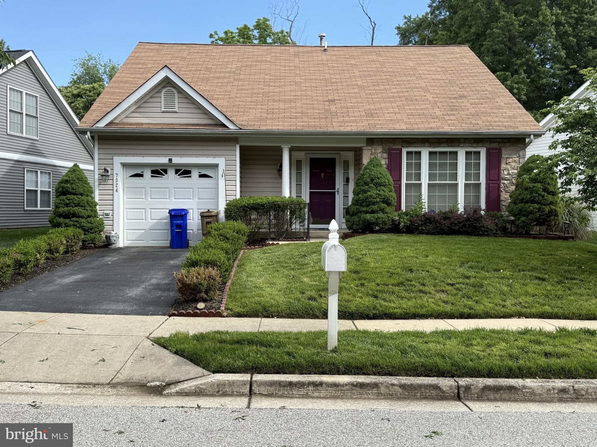 7324 Summerwind Circle Laurel, MD 20707 - Photo 1 of 20 a front view of a house with a yard and garage