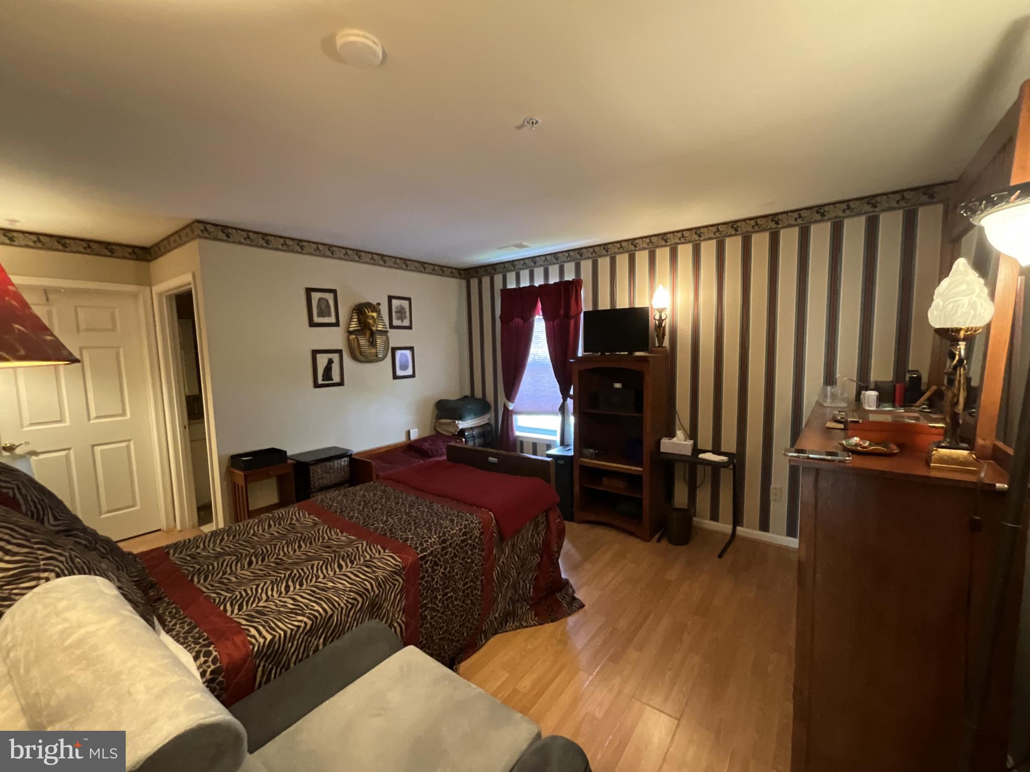 7324 Summerwind Circle Laurel, MD 20707 - Photo 17 of 20 a bedroom with bed and wooden floor