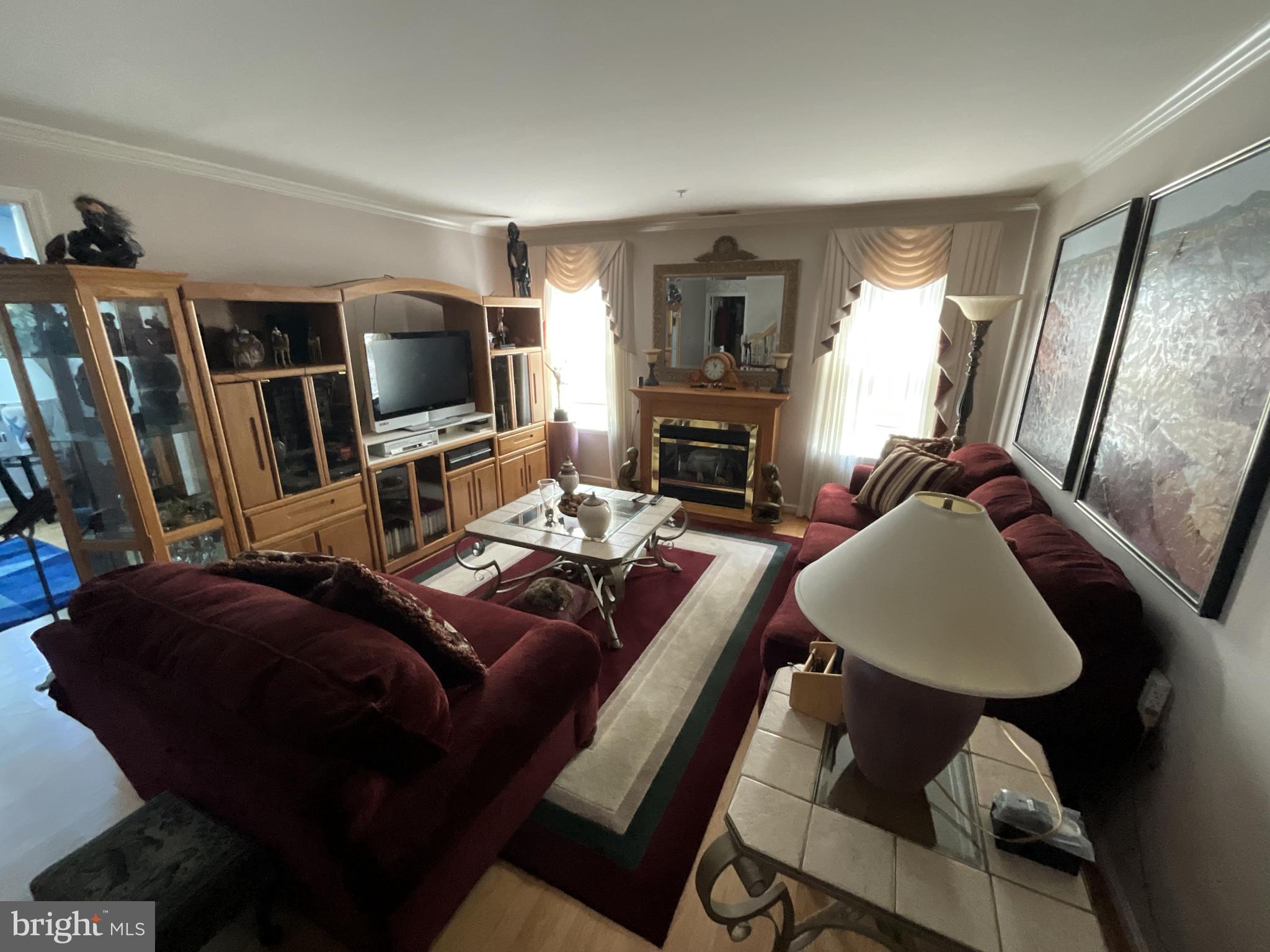 7324 Summerwind Circle Laurel, MD 20707 - Photo 6 of 20 a bed room with a bed furniture and a flat screen tv